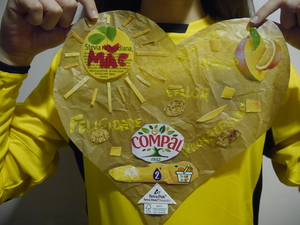 A autora do trabalho com uma camisola amarela onde se destaca o coração elaborado